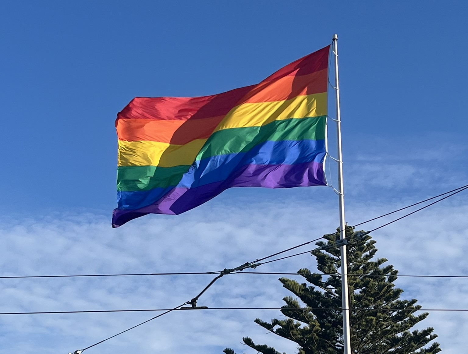 flag above Harvey Milk Plaza