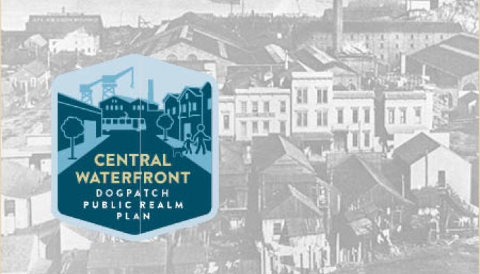 A black and white historical photograph of an industrial waterfront area featuring a large factory with several smoking chimneys and a cluster of classic San Francisco houses, with a blue graphic overlay in the bottom left corner that reads Central Waterfront Dogpatch Public Realm Plan.