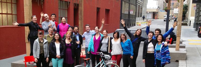 people in alley waving and smiling