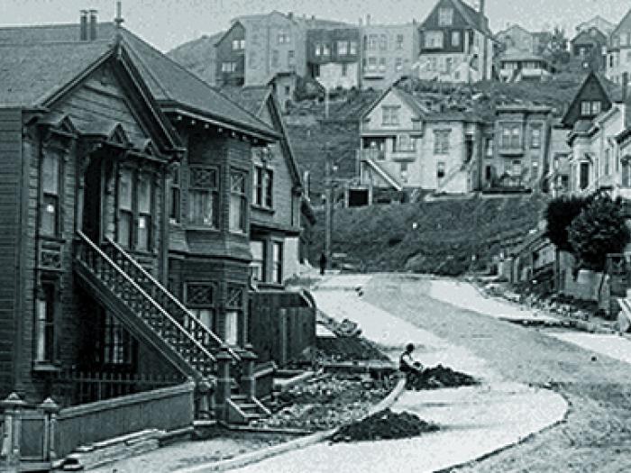 Historic black-and-white view of Corbett Heights showing modest houses lining unpaved dirt streets on a sparsely developed hillside.