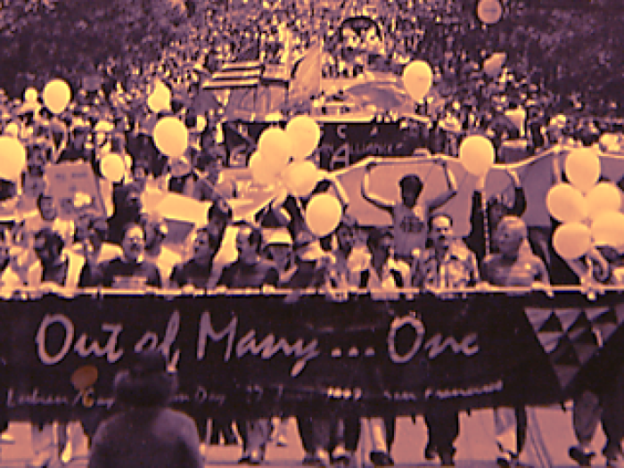 Festive banner featuring an historic black-and-white photo of LGBTQ community life at a rally with rainbow-colored graphics and the title Out of Many, One.