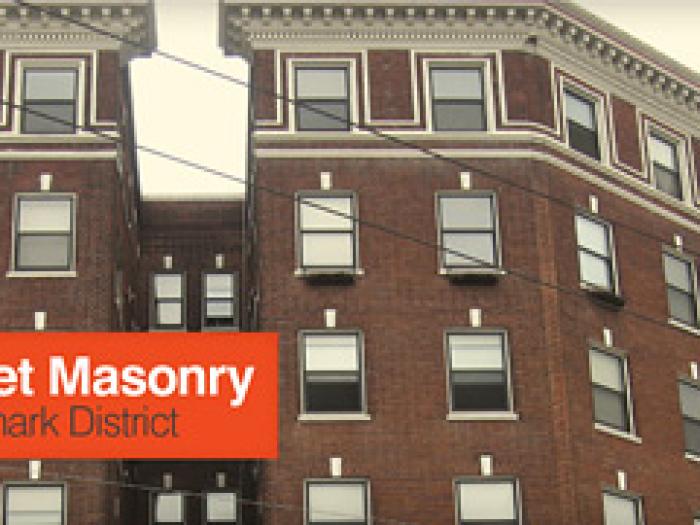 A banner image titled Market Street Masonry Proposed Landmark District, featuring a wide-angle, low-perspective view of several historic red brick and masonry buildings with classic architectural details along a city street corner.