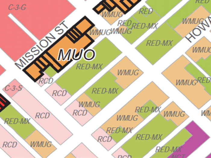 A colorful zoning map of the Western SoMa neighborhood showing adjacent parcel rezoning. The map uses various color-coded blocks to identify zoning districts, including MUO (Mixed Use-Office), WMUG (Western SoMa Mixed Use-General), and RED-MX (Residential Enclave Mixed). Major streets like Mission Street and Howard Street are labeled, with arrows indicating specific areas of zoning changes.