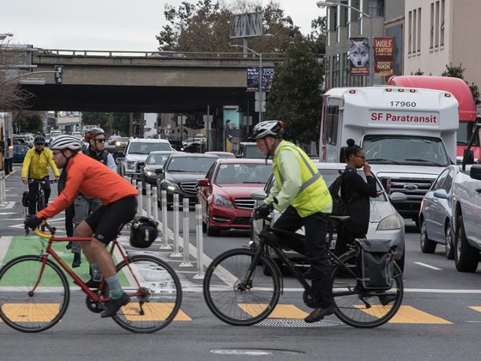 cyclists and cars at an intersection