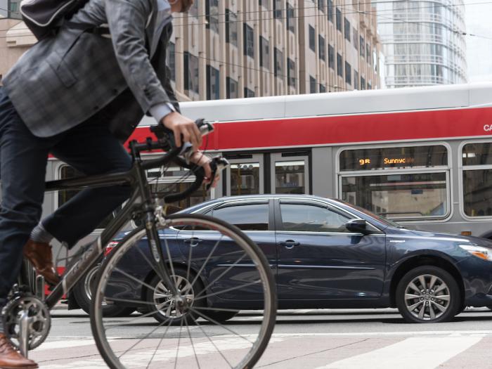 Bicycle, car and bus on Market Street - SFMTA