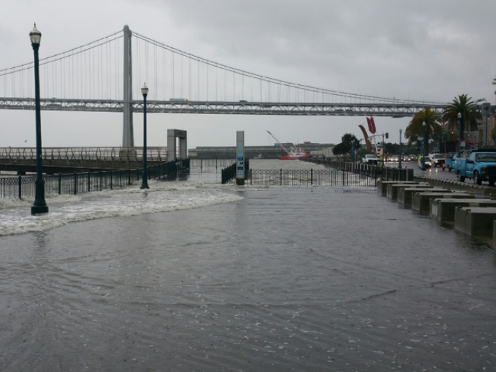 sea water overflows onto sidewalk