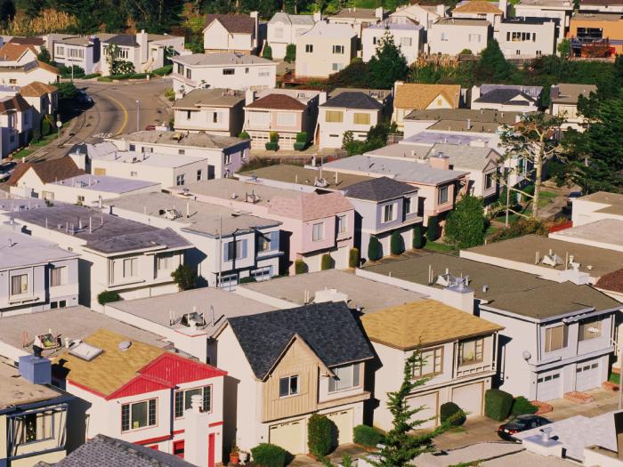 Aerial view showing rows of houses along a street. Photo by Adobe Stock/spiritofamerica