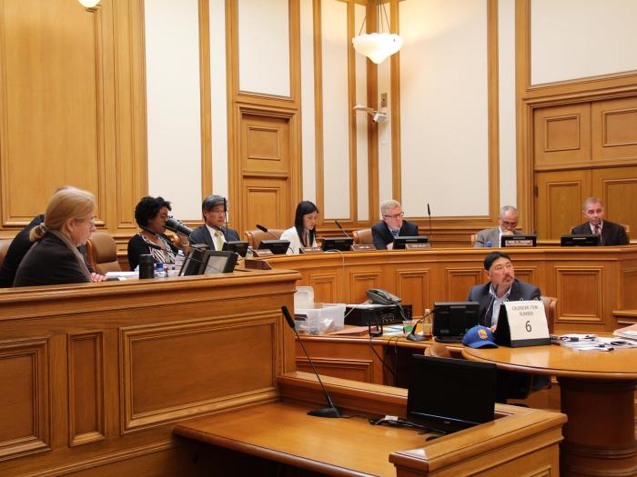 Members of the San Francisco Planning Commission and staff presiding over a public hearing at City Hall.